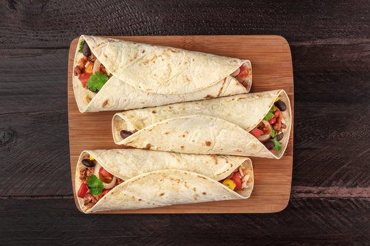 Mexican burritos on a dark background with copy space