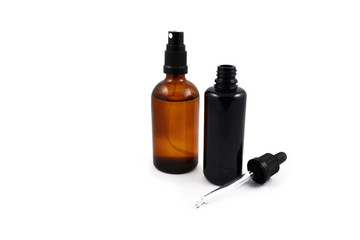 Cosmetic bottle stock images. Brown cosmetic bottle with batcher. Vials on a white background