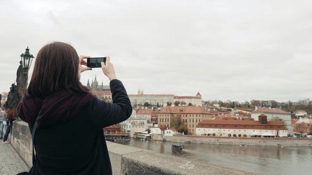 Beautiful Young Woman Tourist In Prague, Making Selfie or Taking Photo With Her Mobile Phone, Travelling Concept