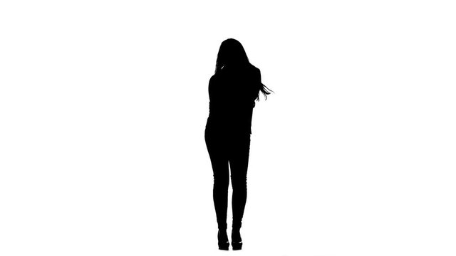 Girl sings incendiary songs into the microphone. White background. Silhouette. Slow motion