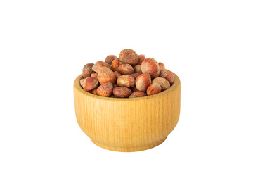 nuts of Turkish hazel in a composition with money wooden bowl and spoon scattered on a table isolate on a white background