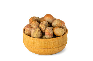 nuts of Turkish hazel in a composition with money wooden bowl and spoon scattered on a table isolate on a white background