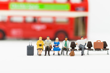 Miniature people : people waiting for bus at bus station using as background travel, business trip or transportation concept.