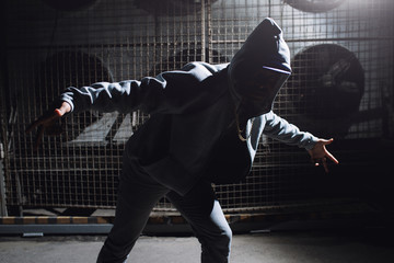 Rapper dancing in dark urban city scene