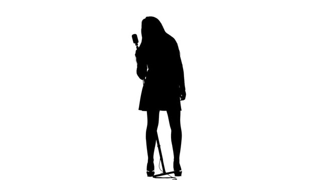 Singer performs songs in a retro microphone sexually moving. White background. Silhouette. Slow motion