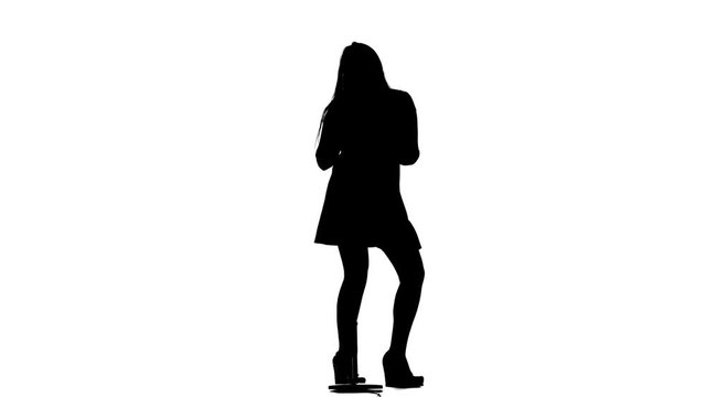 Singer performs her song of authorship. White background. Silhouette. Slow motion