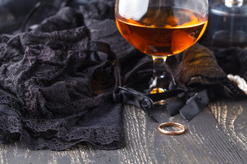 Female lingerie and accessories with glass of cognac