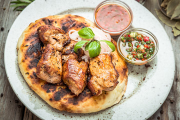 two pieces of of grilled pork with herbs on a paper