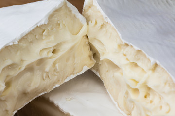 Close up of Camembert cheese. Brie with coarse edge broken into pieces cremy and delicious.