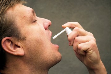 the man uses the inhaler