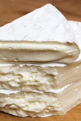 Close up of stacked and melted Camembert cheese brie.