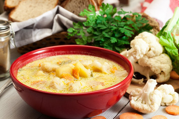 Vegetable soup with ingredients carrot, cauliflower, potato and parsley