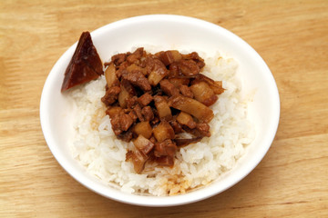 Braised pork rice on wood table