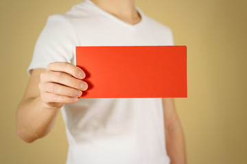 Man showing blank red flyer brochure booklet. Leaflet presentation. Pamphlet hold hands. Man show clear offset paper. Sheet template. Booklet design sheet display read first person