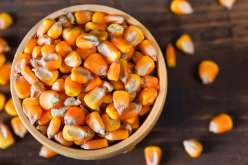 Close up corn seeds in bowl on wooden table