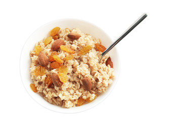 Tasty oatmeal with raisins and almond in bowl on white background