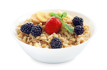 Tasty oatmeal with fruit and berries in bowl on white background