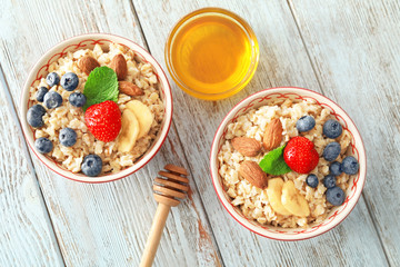 Composition with tasty oatmeal on table