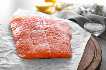 Fresh raw salmon fillet on parchment, closeup