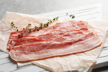 Rashers of bacon on wooden board