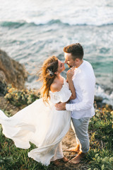 A loving couple is walking on the beach