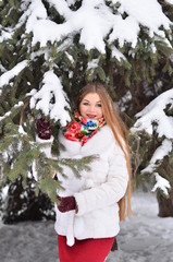 Girl smiling in the woods in the Russian national scarf in winter.
