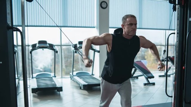 Bodybuilder workout in gym machine