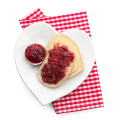 Gravy boat and bread with strawberry jam on plate, isolated on white