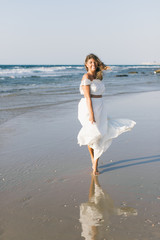 beautiful girl walks on the beach