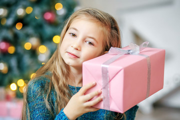 Beautiful child received a gift box. Concept New Year, Merry Christmas, holiday, vacation, winter, childhood.