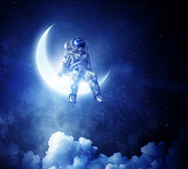Astronaut sit on crescent moon. Mixed media