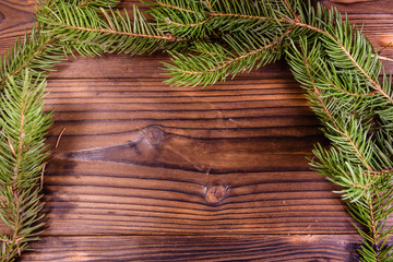 Branch of the fir tree on wooden table. Copy space