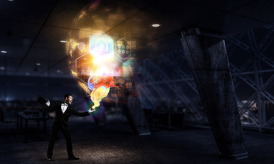 Businessman demonstrating magic . Mixed media