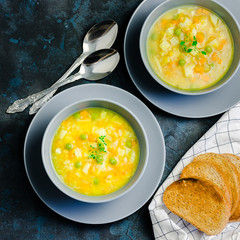 Slow cooker grren peas turmeric soup on dark blue stone background. Top view, copy space. 