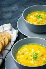 Detox crock pot split pea soup on dark blue stone background. Selective focus, copy space.