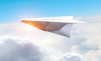 Origami plane flying in sky. Mixed media
