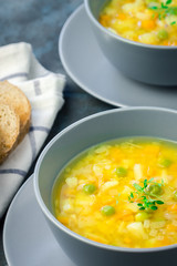 Vegan cauliflower split pea turmeric soup on dark blue stone background.  Selective focus, copy space.