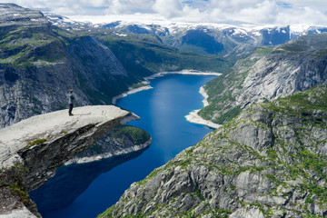 Person admiring the landscape at Trolltunga, Norway