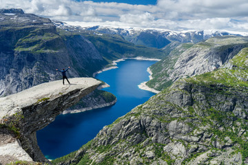 Person admiring the landscape at Trolltunga, Norway