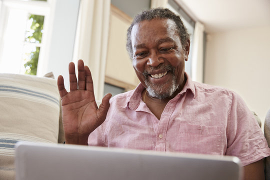 Senior Man Using Laptop To Connect With Family For Video Call