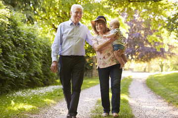 Grandparents On Walk In Countryside With Baby Grandson