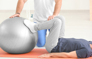 Physiotherapist working with patient in clinic
