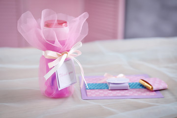 Soap bubble bottle, Thank you card and small chocolates on table