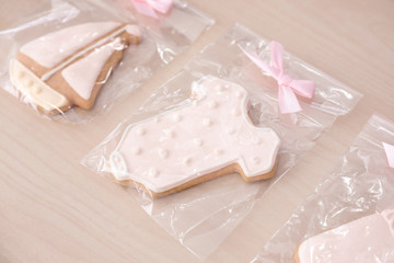 Fototapeta na wymiar Cute cookies for baby shower on wooden background