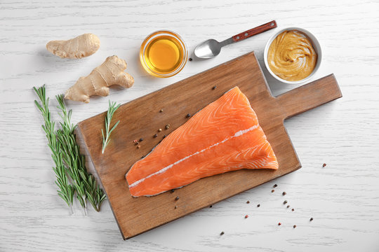 Fresh salmon fillet and ingredients for marinade on table