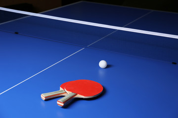 Ping pong rackets and ball on table