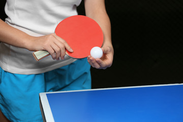 Woman playing table tennis indoors