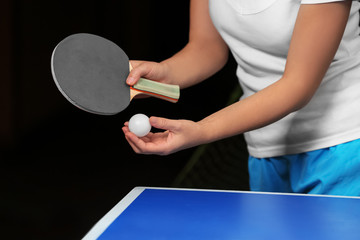 Woman playing table tennis indoors