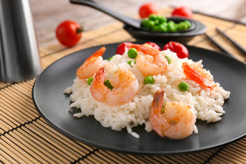 Plate with delicious shrimp fried rice on table