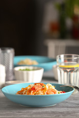 Plate with delicious shrimp fried rice on table